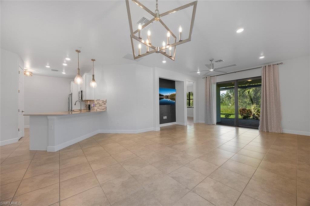 5845 Mayflower Way Ave Maria, FL 34142 - Photo 4 of 48 a view of an empty room and kitchen with a floor to ceiling window