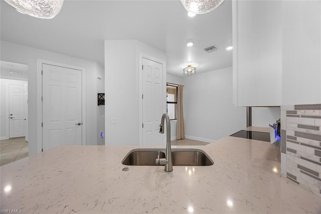 5845 Mayflower Way Ave Maria, FL 34142 - Photo 9 of 48 a kitchen with a sink and a large mirror