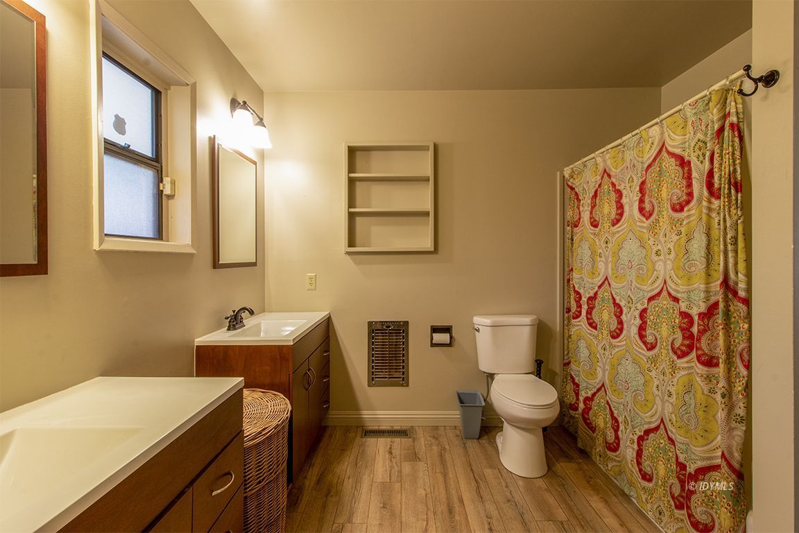 26890 Saunders Meadow Road Idyllwild, CA 92549 - Photo 33 of 44 a bathroom with a sink a toilet and a shower curtain
