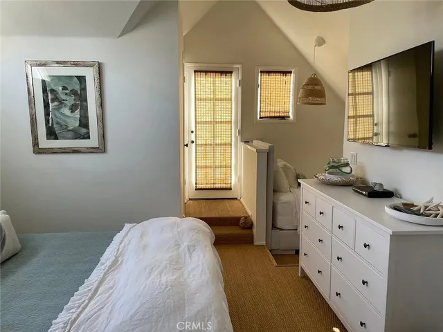 a bedroom with a bed and a dresser in it