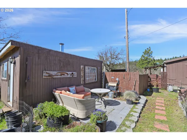 a view of a backyard with large trees