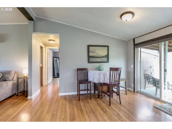 a kitchen with a table chairs refrigerator and cabinets