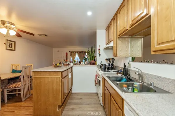 a kitchen with stainless steel appliances granite countertop lots of counter top space and wooden floor