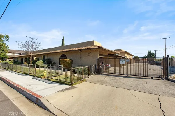 a view of a house with a wooden fence