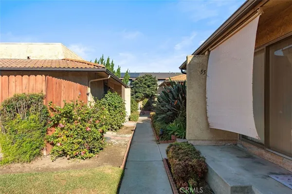 a couple of potted plants in front of a door
