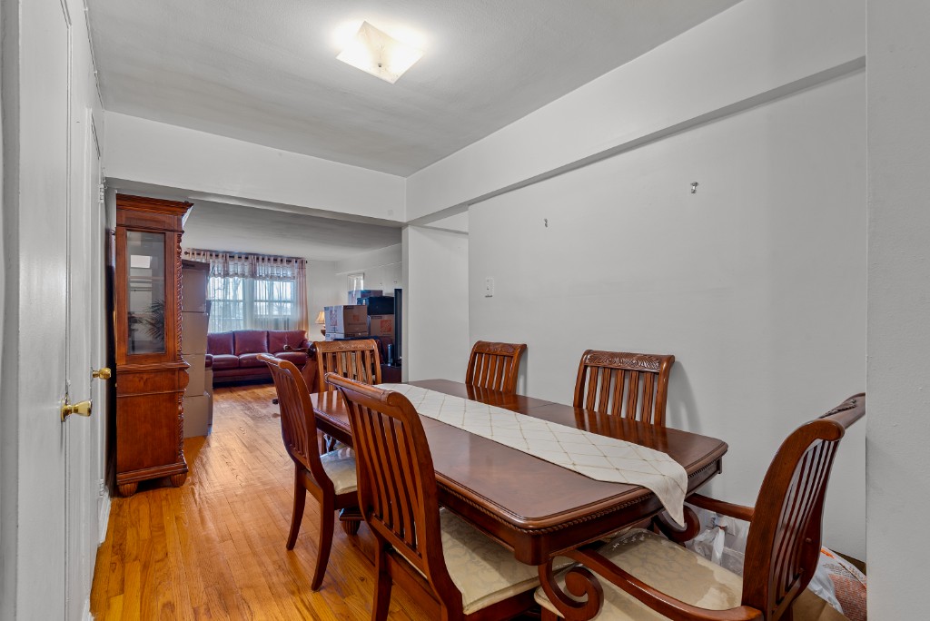 60-11 Broadway, Unit 3C Queens, NY 11377 - Photo 16 of 18 a dining room with furniture and window