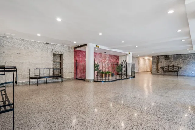 a view of a room with gym equipment and a large window
