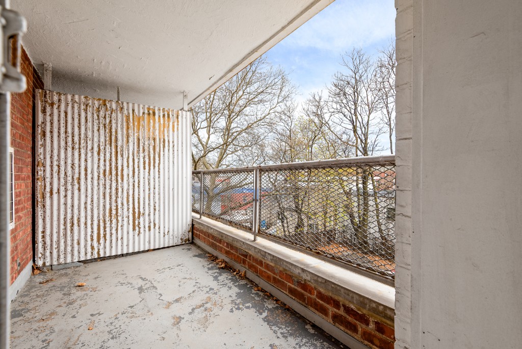 60-11 Broadway, Unit 3C Queens, NY 11377 - Photo 8 of 18 a view of a room with wooden floor and windows