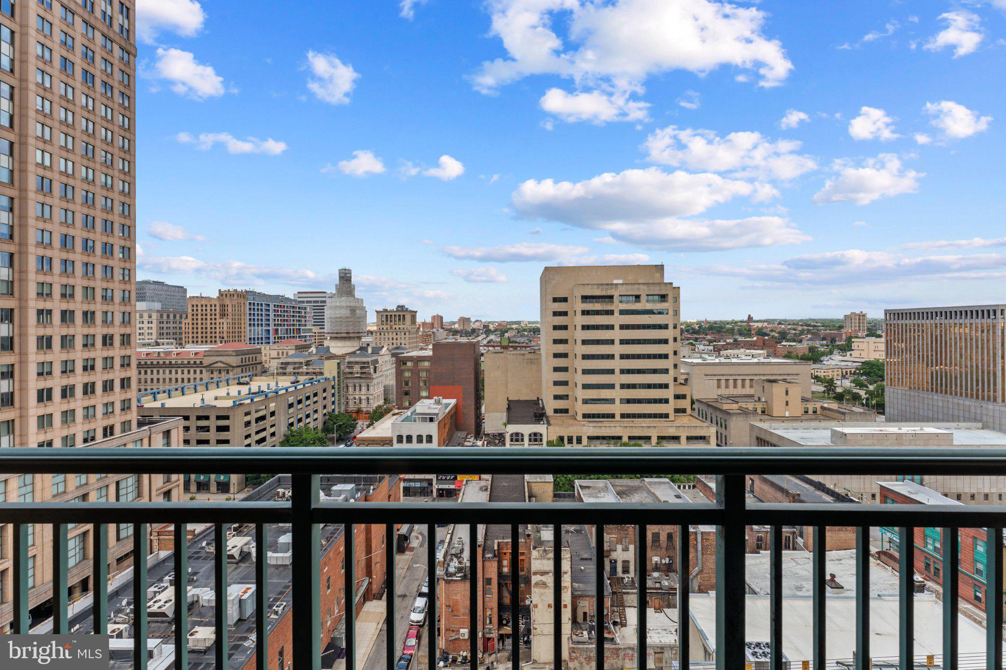 414 Water Street, Unit 1306 Baltimore, MD 21202 - Photo 16 of 29 Urban skyline with vibrant clouds.