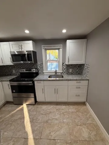 a kitchen with a sink and cabinets