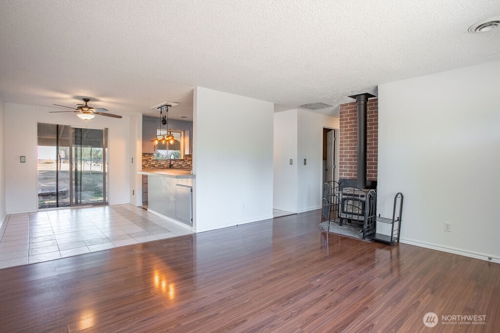 651 Jorgensen Road Onalaska, WA 98570 - Photo 2 of 36 a view of an empty room with wooden floor and a kitchen