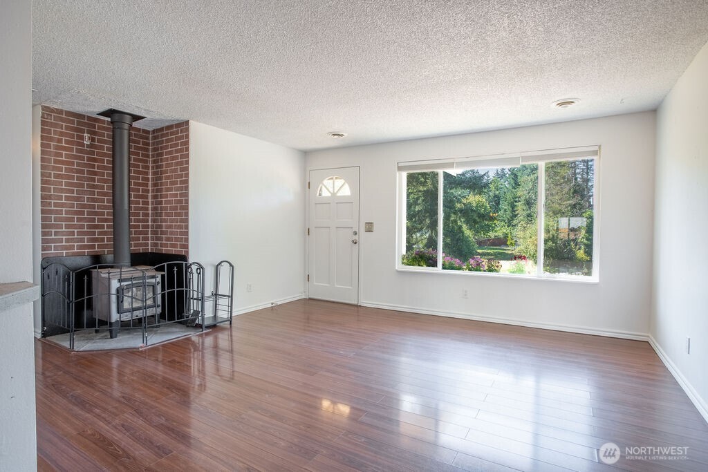 651 Jorgensen Road Onalaska, WA 98570 - Photo 3 of 36 wooden floor in an empty room with a window
