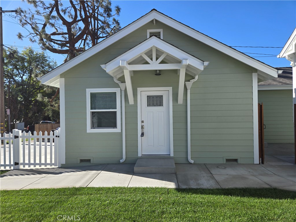 119 Norumbega Drive, Unit 1 Monrovia, CA 91016 - Photo 1 of 14 a front view of a house with a yard