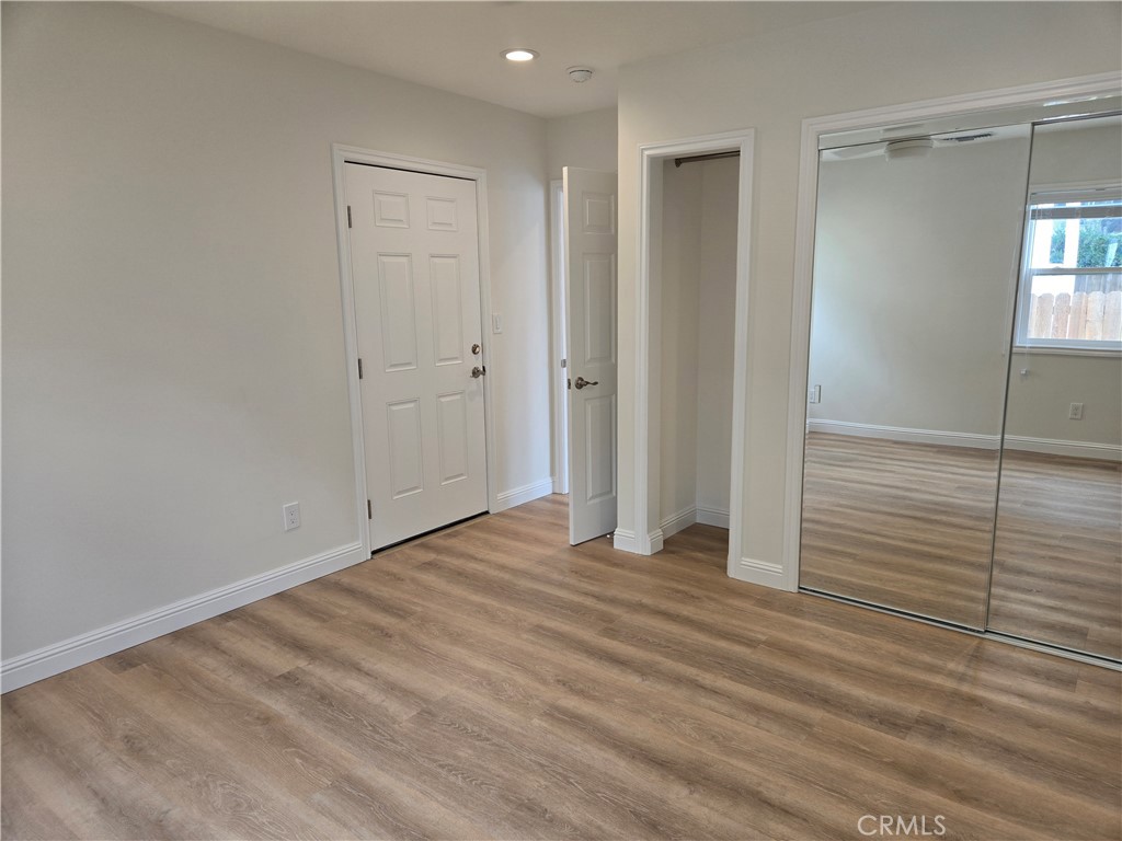 119 Norumbega Drive, Unit 1 Monrovia, CA 91016 - Photo 12 of 14 a view of an empty room with wooden floor and closet area