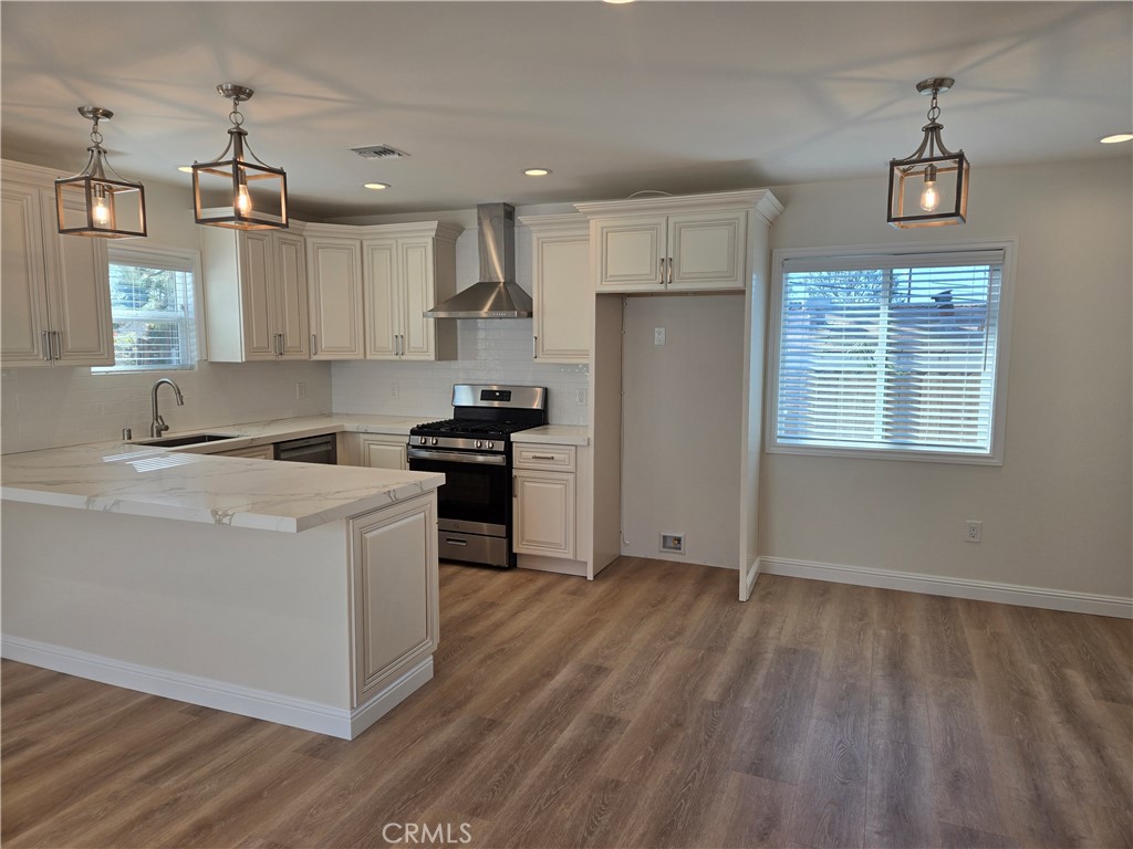 119 Norumbega Drive, Unit 1 Monrovia, CA 91016 - Photo 6 of 14 a kitchen with kitchen island wooden floors appliances and cabinets