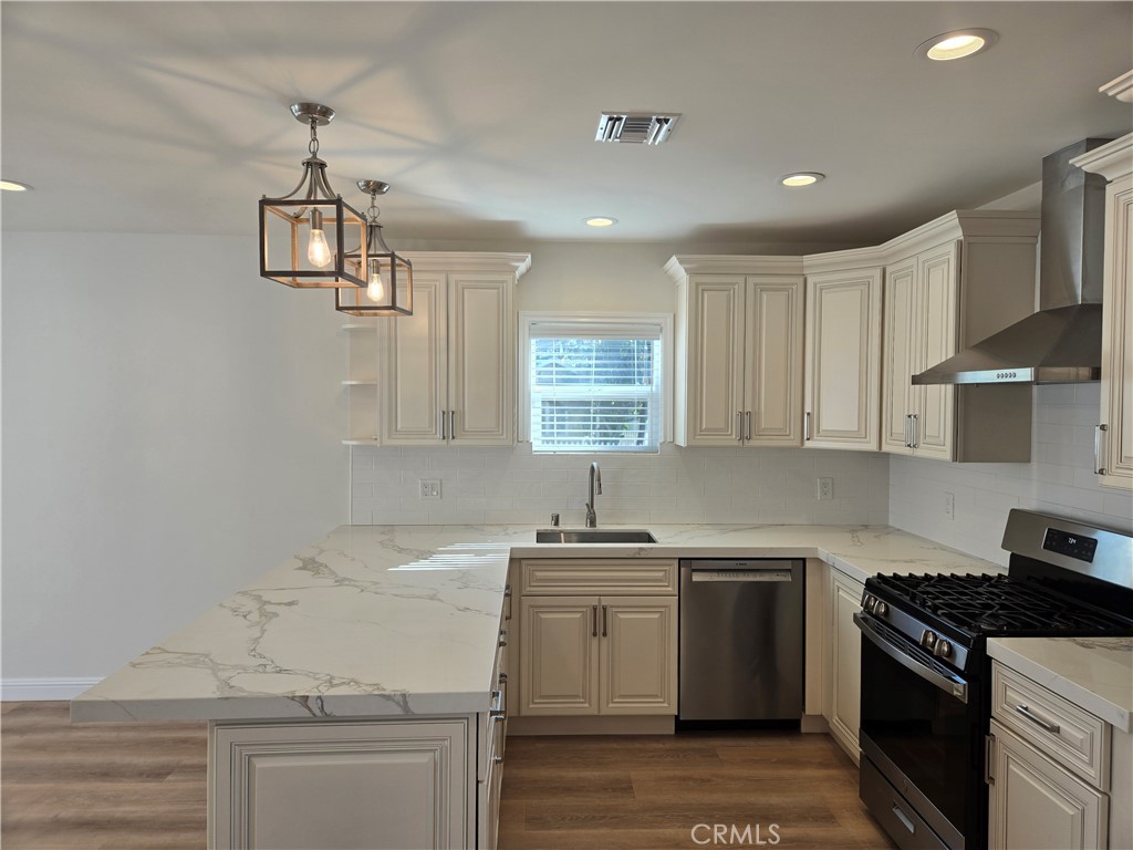 119 Norumbega Drive, Unit 1 Monrovia, CA 91016 - Photo 7 of 14 a kitchen with granite countertop a sink stainless steel appliances and cabinets