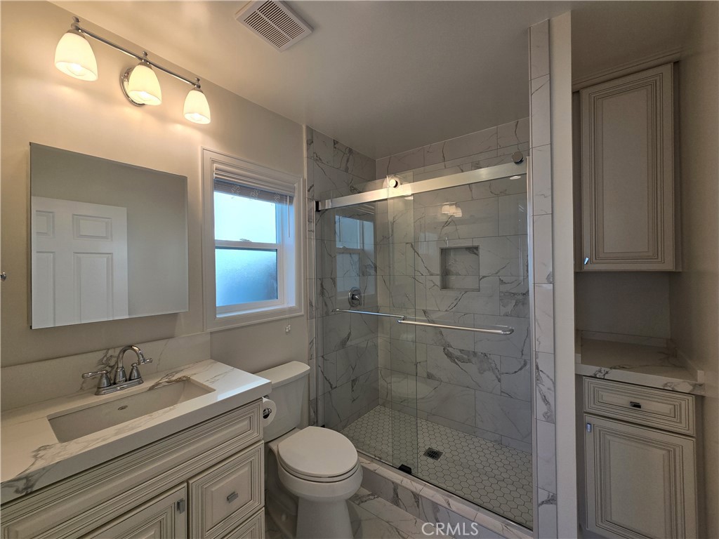 119 Norumbega Drive, Unit 1 Monrovia, CA 91016 - Photo 10 of 14 a bathroom with a sink a toilet and shower