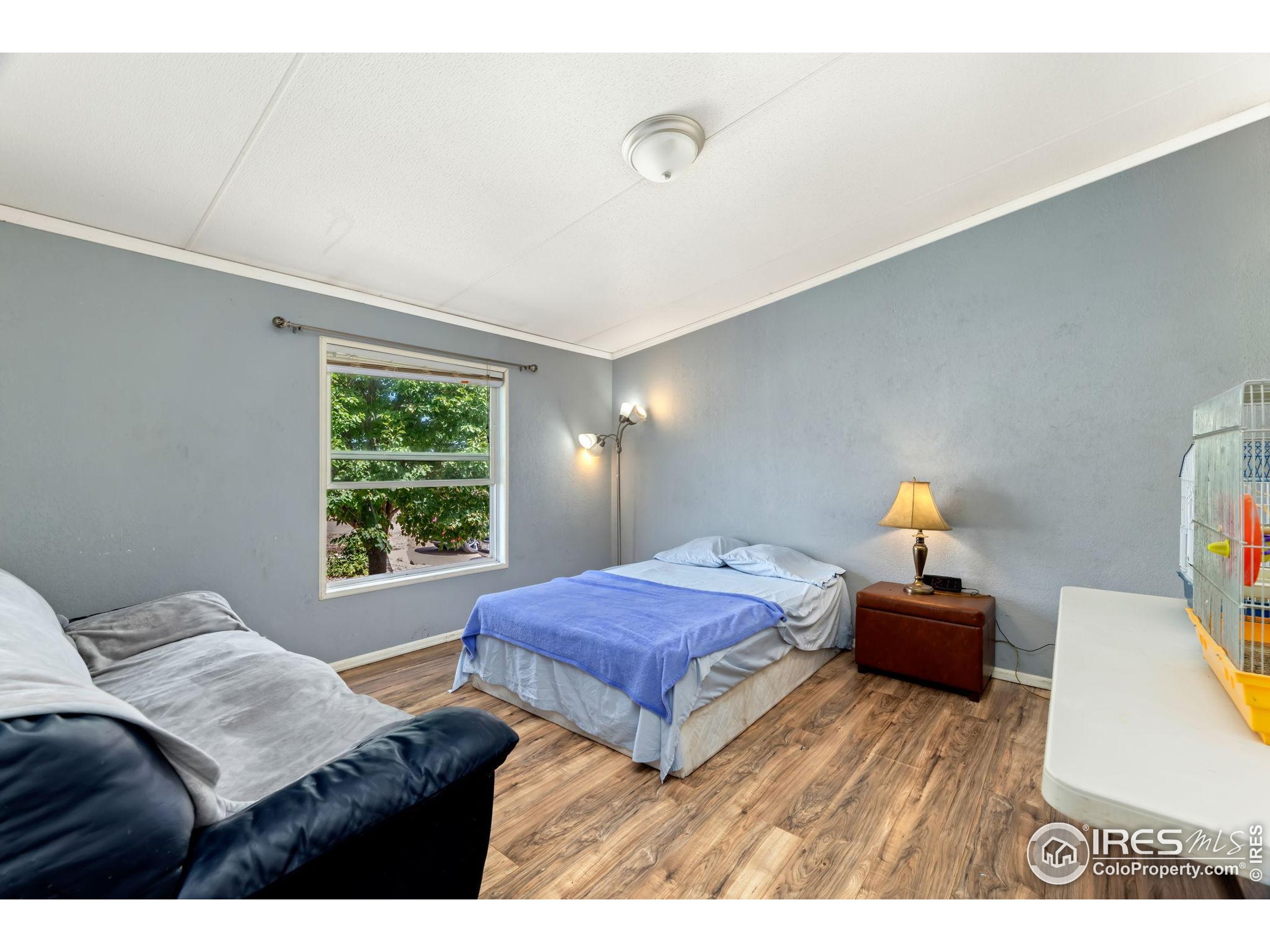 218 Grape Street, Unit 29 Hudson, CO 80642 - Photo 12 of 26 a bedroom with a bed and window