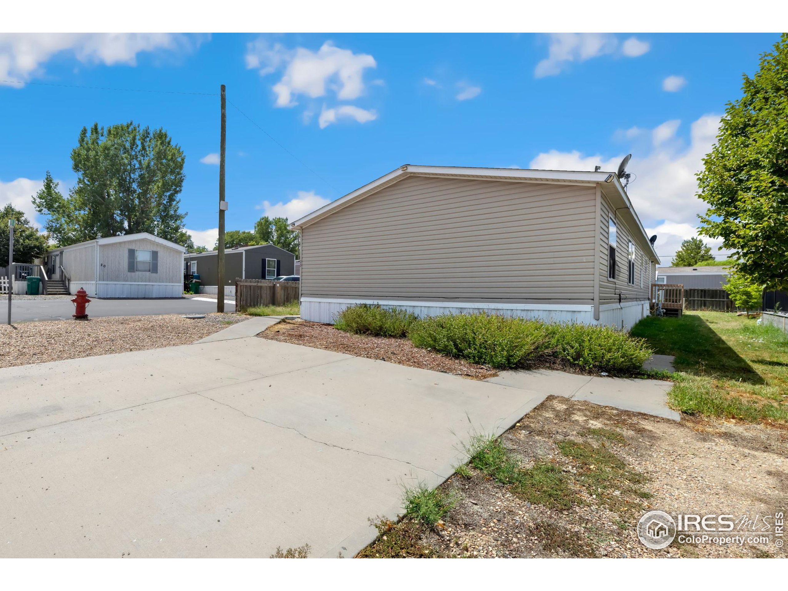 218 Grape Street, Unit 29 Hudson, CO 80642 - Photo 18 of 26 a backyard of a house with yard and outdoor seating