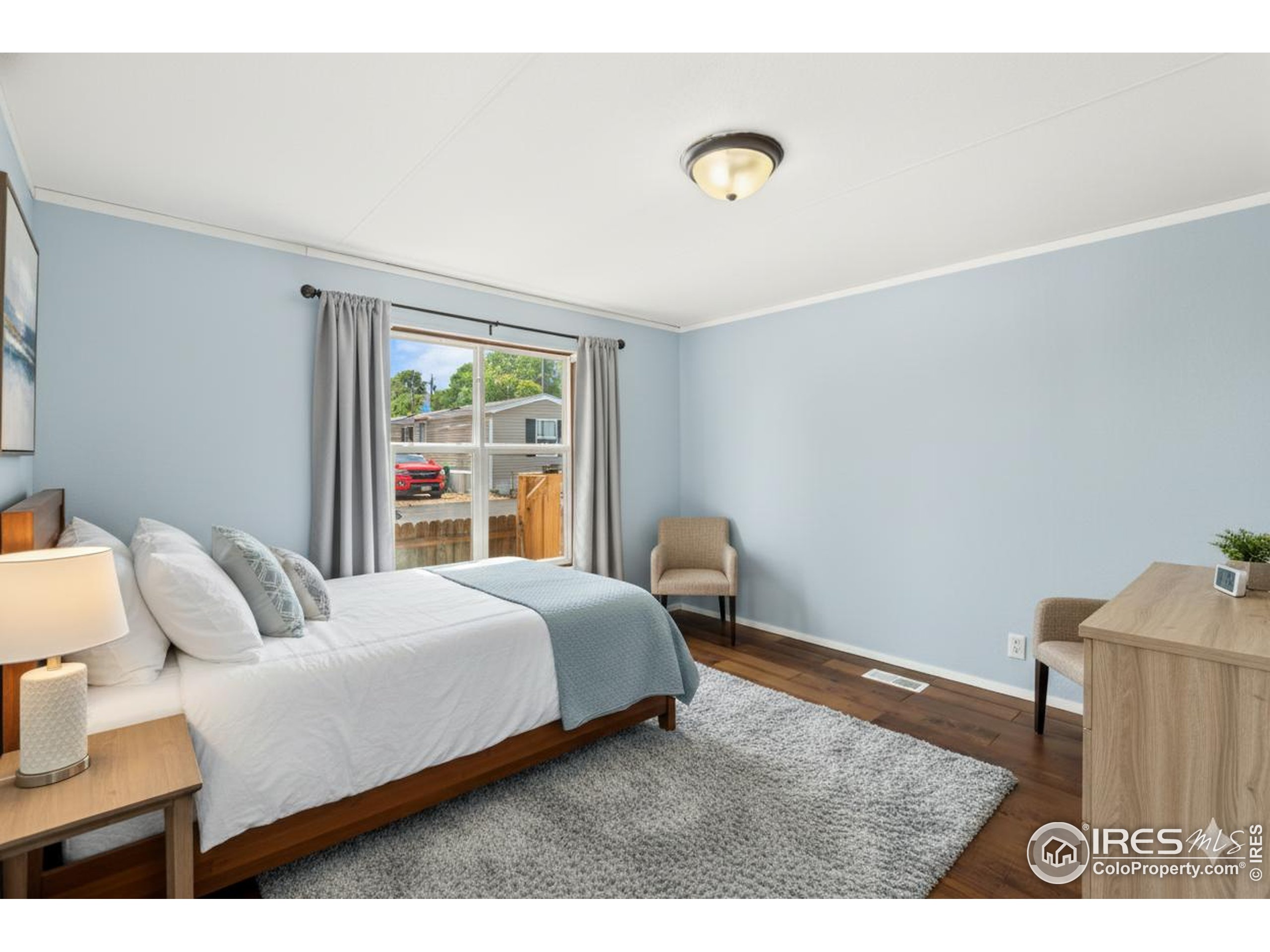 218 Grape Street, Unit 29 Hudson, CO 80642 - Photo 2 of 26 a bedroom with a bed and a window