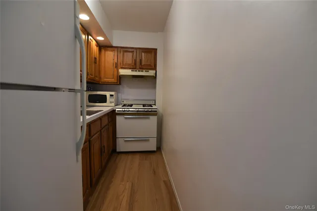 a kitchen with a sink a microwave a stove and refrigerator