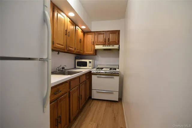 a kitchen with stainless steel appliances a sink and cabinets