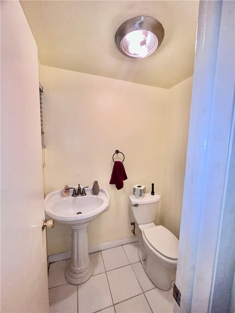 Undisclosed Address Margate, FL 33063 - Photo 4 of 15 a bathroom with a sink a toilet and a mirror