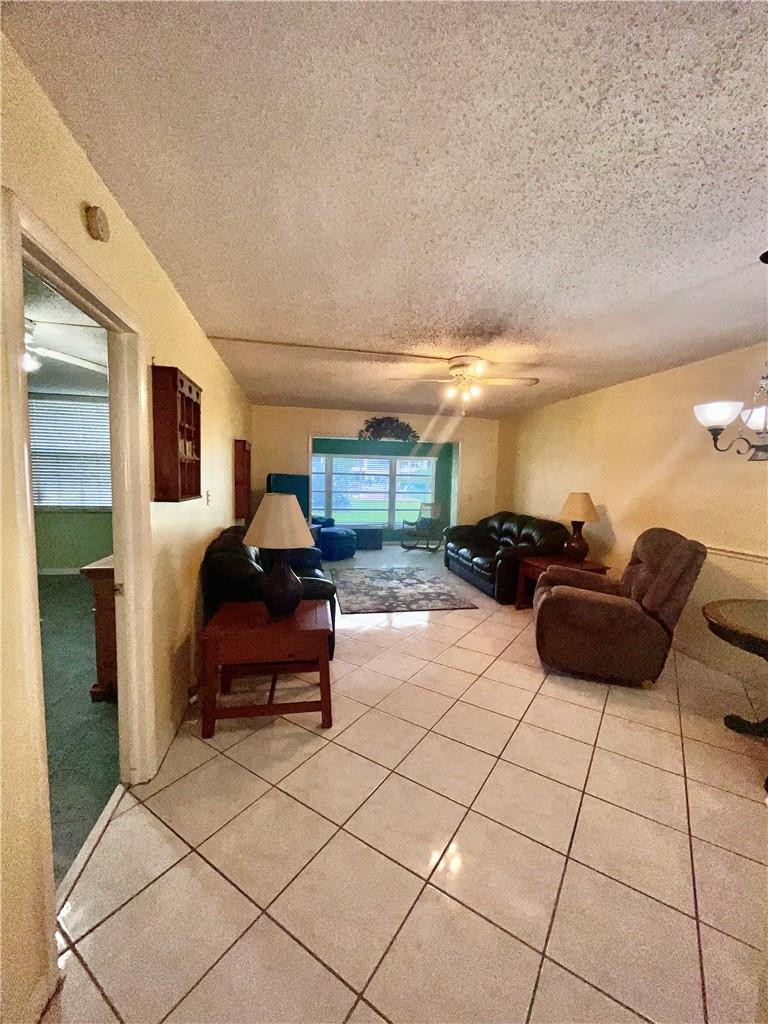 Undisclosed Address Margate, FL 33063 - Photo 7 of 15 a living room with furniture and a chandelier