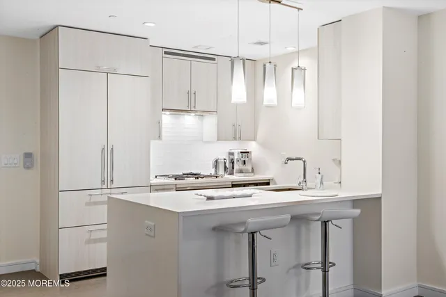 a kitchen with kitchen island a sink appliances and cabinets