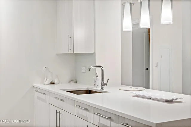 a kitchen with a sink and cabinets