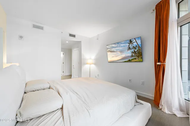 a bedroom with a bed and a painting on the wall