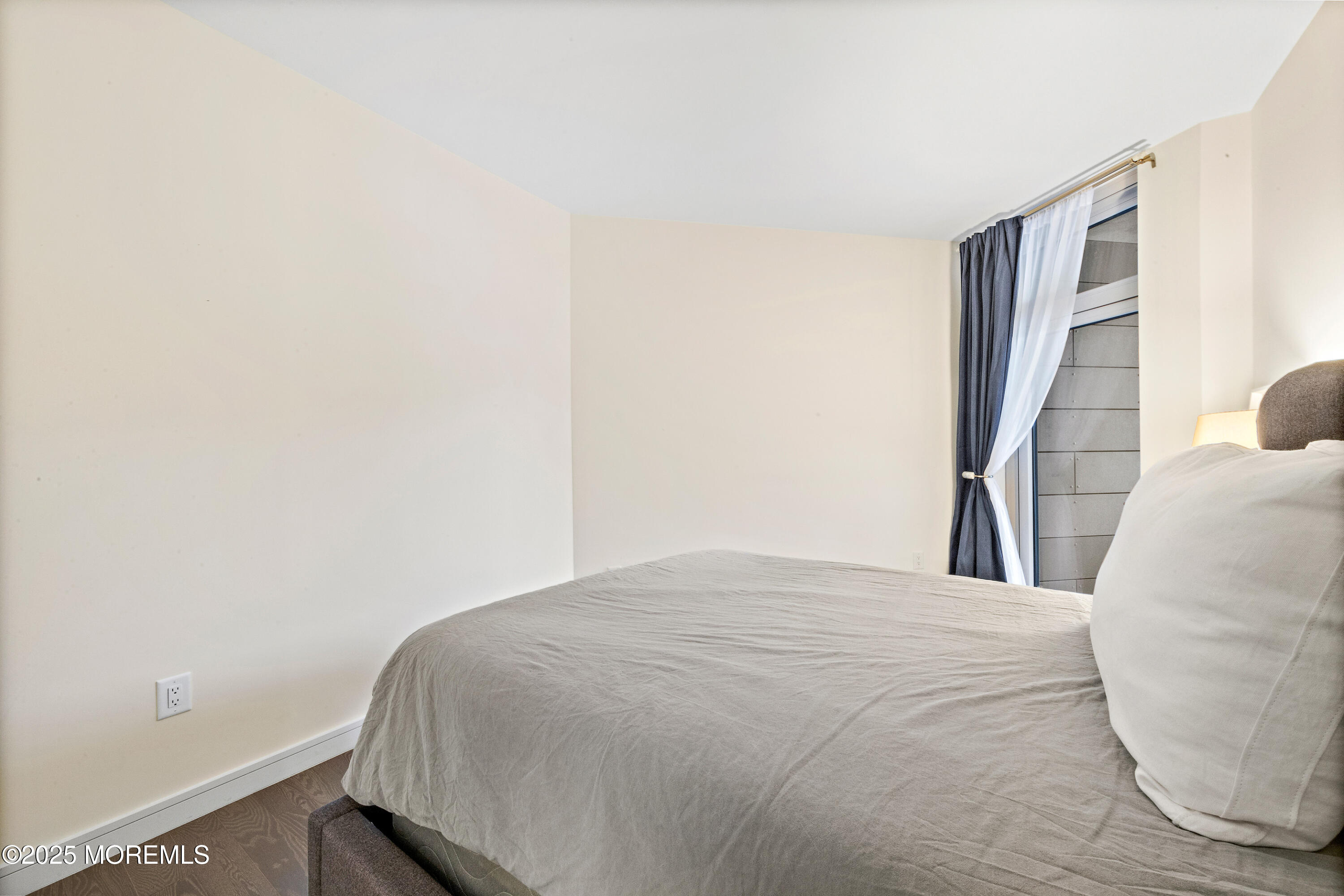 15 Morris Avenue, Unit 202 Long Branch, NJ 07740 - Photo 22 of 43 a bedroom with a bed and a window