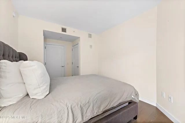 a bedroom with a bed and a mirror