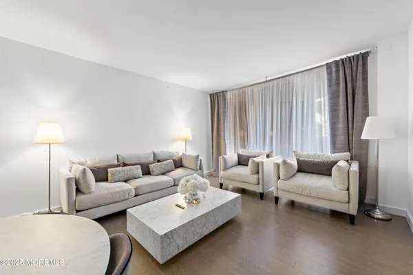 a kitchen with a sink a stove a refrigerator and white cabinets