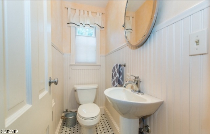 17 Bailey Road Millburn, NJ 07041 - Photo 12 of 24 a bathroom with a sink toilet and a mirror