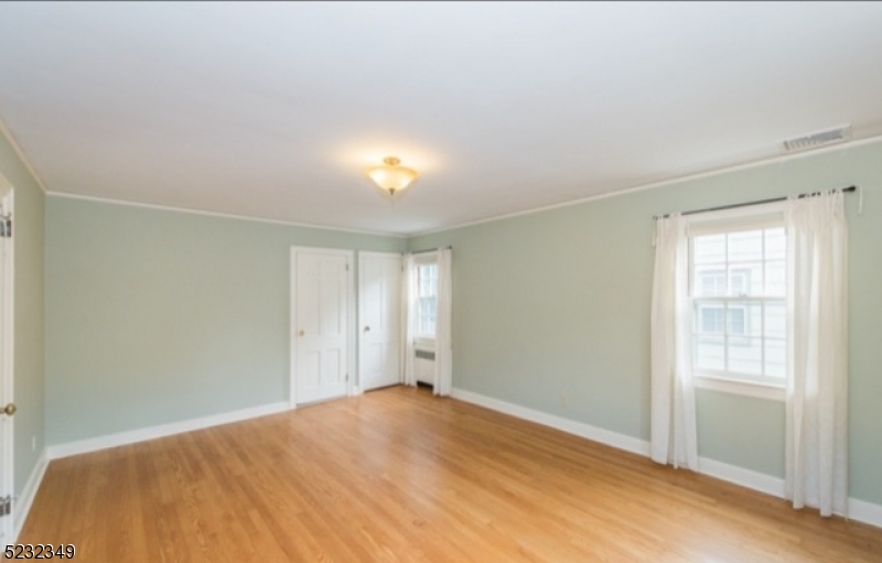 17 Bailey Road Millburn, NJ 07041 - Photo 14 of 24 a view of empty room with window and wooden floor
