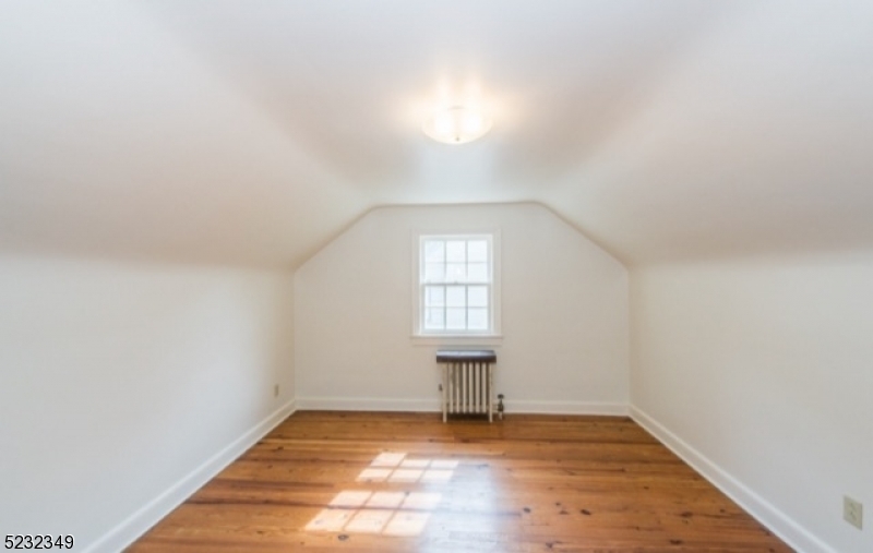 17 Bailey Road Millburn, NJ 07041 - Photo 16 of 24 an empty room with wooden floor and windows