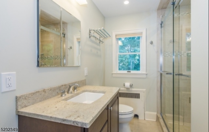 17 Bailey Road Millburn, NJ 07041 - Photo 17 of 24 a bathroom with a granite countertop sink toilet and a mirror