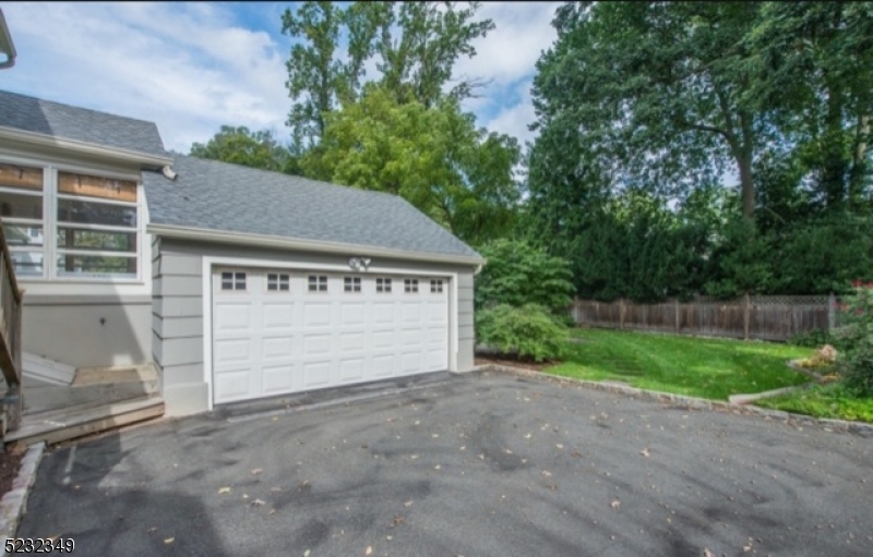 17 Bailey Road Millburn, NJ 07041 - Photo 21 of 24 a view of a house with a yard and garage