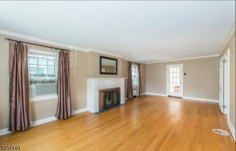 17 Bailey Road Millburn, NJ 07041 - Photo 3 of 24 a view of empty room with a fireplace and a window