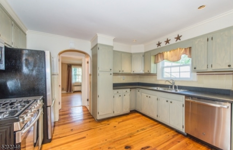 17 Bailey Road Millburn, NJ 07041 - Photo 8 of 24 a kitchen with granite countertop a sink stainless steel appliances and cabinets