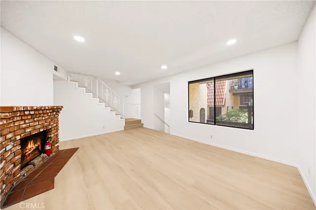 a view of an empty room with a fireplace
