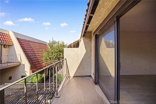a view of staircase with railing and white walls