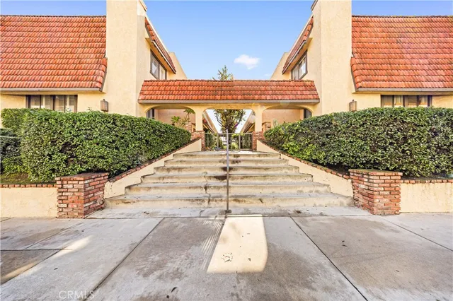 a view of a patio with a table and chairs and potted plants