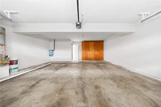 an empty room with a ceiling fan and window
