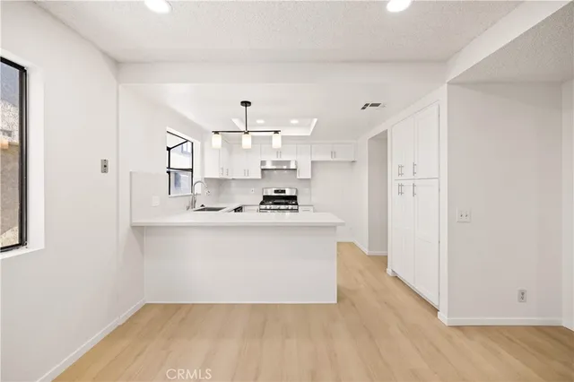 a view of kitchen with sink and wooden floor