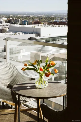 a view of a dining room with furniture and a floor to ceiling window