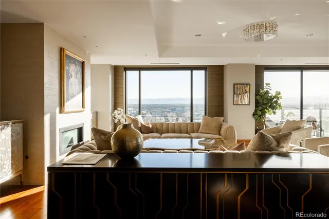 a dining room with furniture a large window and a chandelier