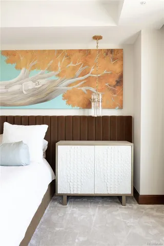 a bedroom with a bed and a night stand