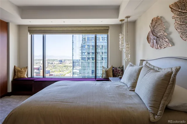 a bed sitting in a bedroom next to a window